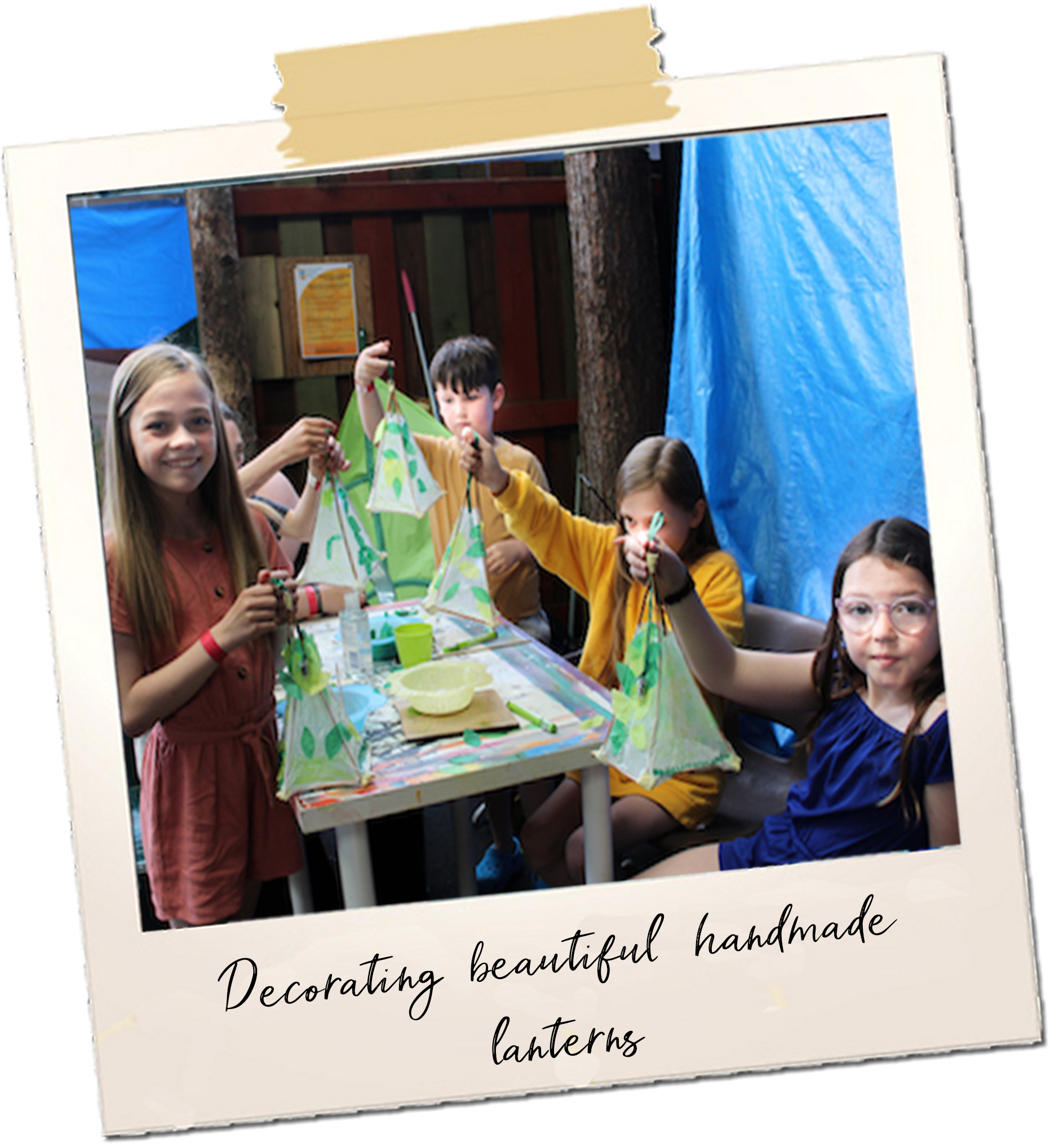 4 young people hold up handmade lanterns decorated with leaves