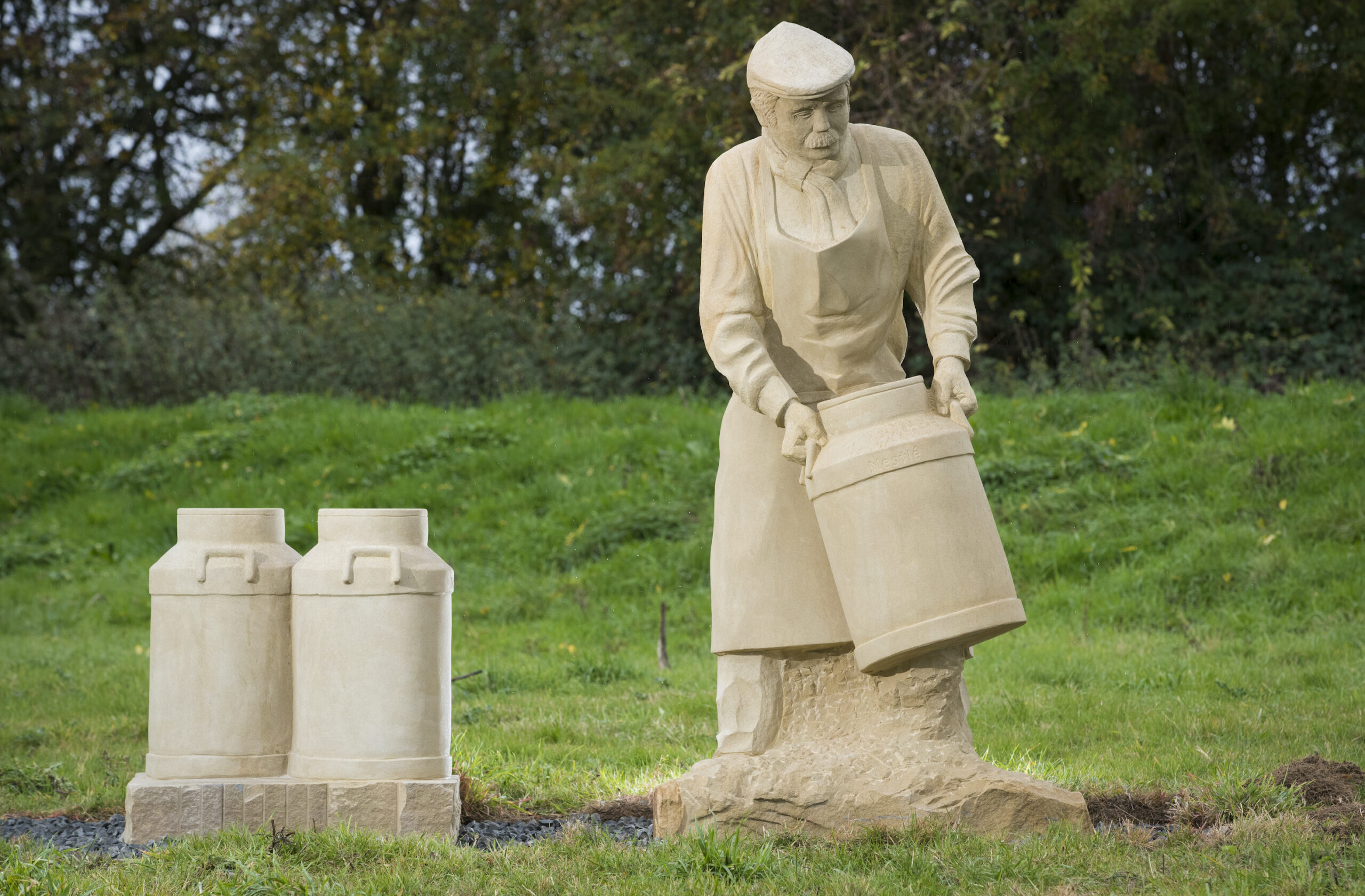 Stone sculpture of farmer in field