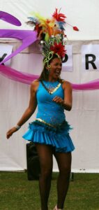 Woman dancing wearing festival clothes in field